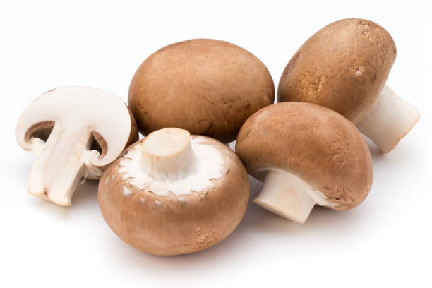 istock Fresh champignon mushrooms isolated on white. 804040140
