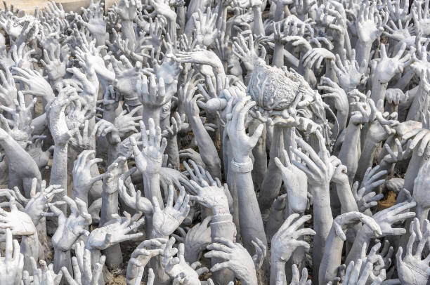 Hand statues in White Temple near Chiang Rai, Thailand stock photo