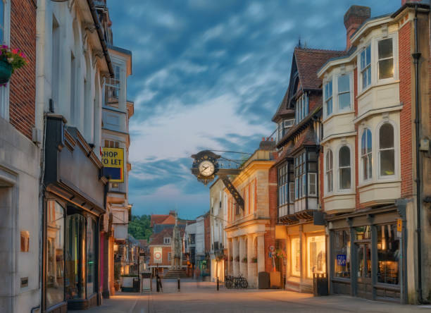 Winchester City centre in England Winchester City centre High Street at night during mid-summer hampshire england photos stock pictures, royalty-free photos & images