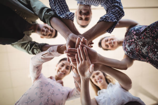 istock Directly below portrait of smiling business people stacking hands 804061432