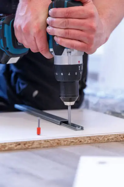 Assembling furniture parts with the cordless screwdriver