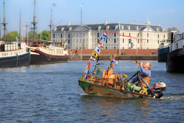 Music boat Musician in a boat on an Amsterdam canal. hurdy gurdy stock pictures, royalty-free photos & images