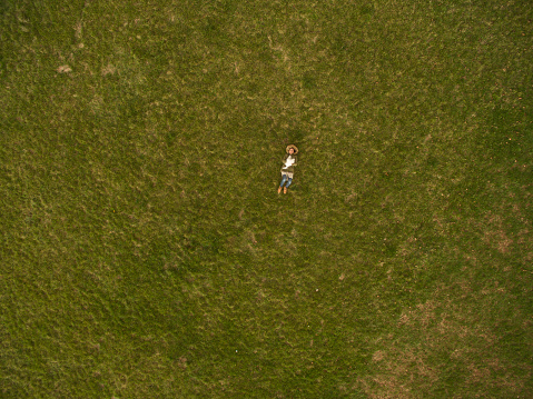 Aerial view of a teenage girl and her white dog,taken with drone
