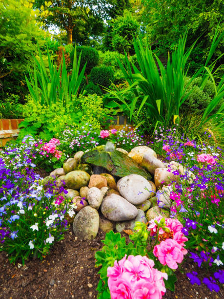 istock Pretty flowerbed with water fountain 804070592