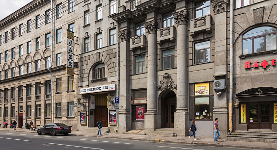 Saint Petersburg, Russia - 9 July, 2015: Jazz Philharmonic Hall on Zagorodny Prospekt avenue, pedestrians on the walkway. Saint Petersburg State Jazz Philharmonic Hall was founded in 1989 by a jazz musician and composer David Goloschokin.