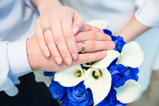 Small Bouquet and Two Wedding Rings. Goods for wedding. This photo is perfect for magazines, shops dealing with wedding dresses ceremonies bride groom marriage jewelry. Can be used for wedding poster