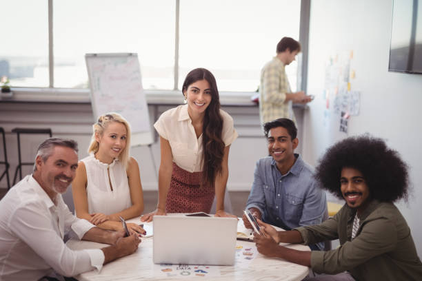 istock smiling business people sitting in creative office 804090454