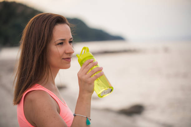 istock Woman athlete holding water bottle 804104140