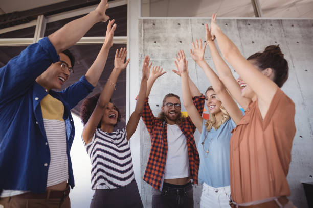 istock Cheerful business people with arms raised 804109376