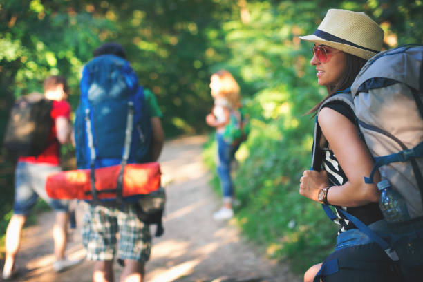 istock Group of young backpackers in the forest walking 804125876