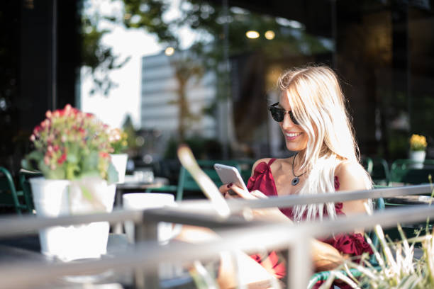 istock happy blonde student woman using a tablet and smiling 804128522