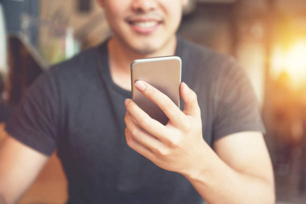 istock Happy man using smartphone at coffee shop and sunlight 804137370