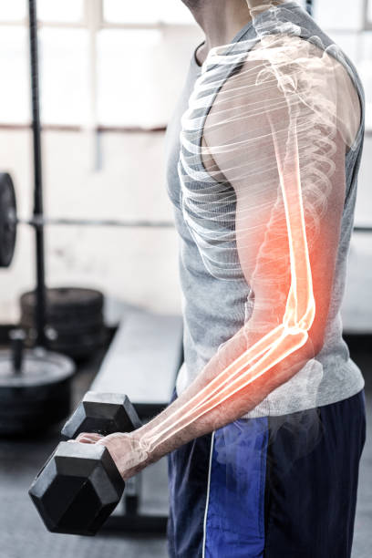 istock Highlighted arm of strong man lifting weights at gym 804137436