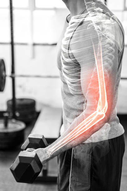 istock Highlighted arm of strong man lifting weights at gym 804137440