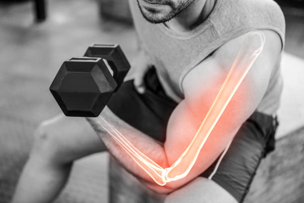 istock Highlighted arm of strong man lifting weights at gym 804139828