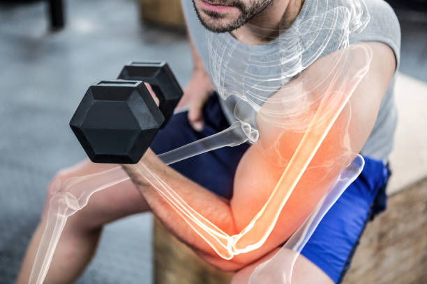 istock Highlighted arm of strong man lifting weights at gym 804139840