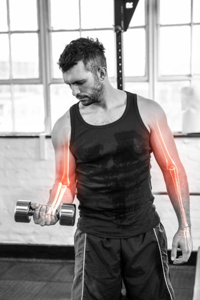 istock Highlighted arm of strong man lifting weights at gym 804139952