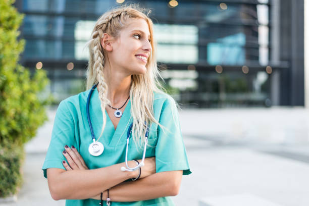 Female doctor, nurse or vet outdoors smiling looking at the camera isolated portrait closeup stock photo