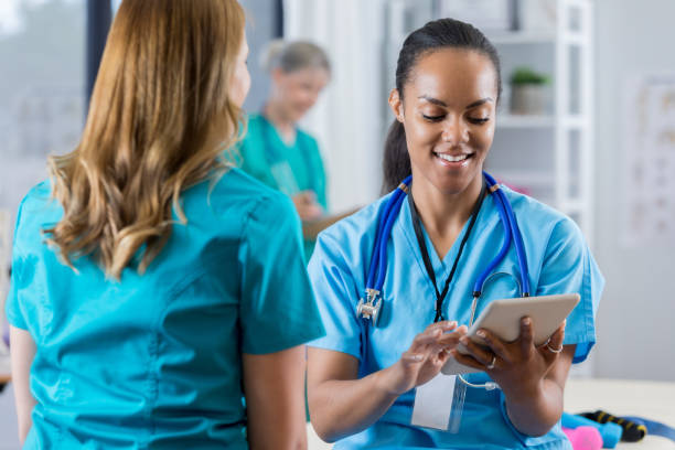 istock Diverse female physical therapists discuss a patient's progress 804143080