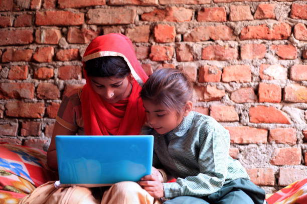 Indian women using laptop at home stock photo