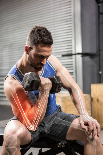 istock Determinated male athlete doing excercise with dumbbells 804154248