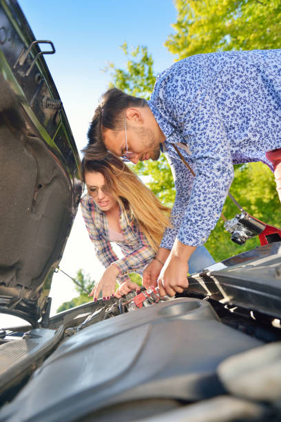 istock Young couple on the road has problems with their car 804154698