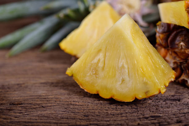 istock portion cut ripe pineapple on wooden table 804159488