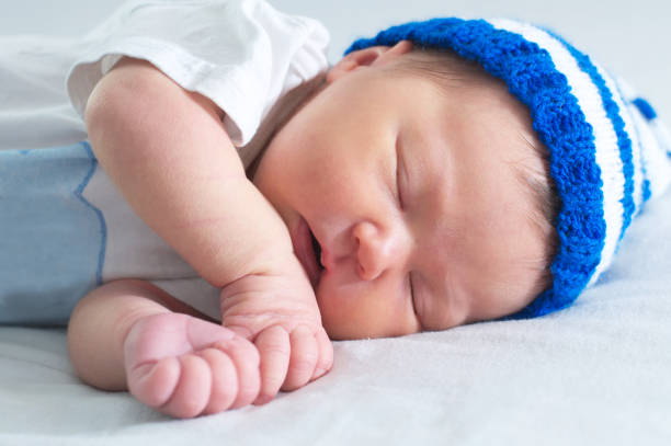 istock baby portrait with jaundice, sleeping newborn in hat on white blanket 804163050