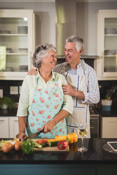 istock Happy senior couple standing together in kitchen 804167846