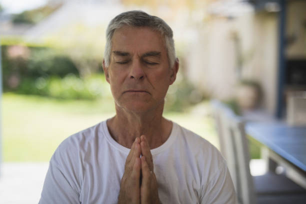 istock Senior man meditating at porch 804170716