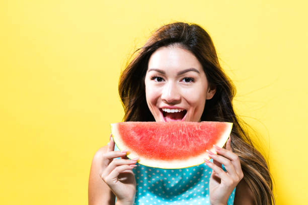 istock Happy young woman holding watermelon 804177996