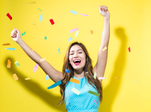 istock Happy woman celebrating with confetti 804178046