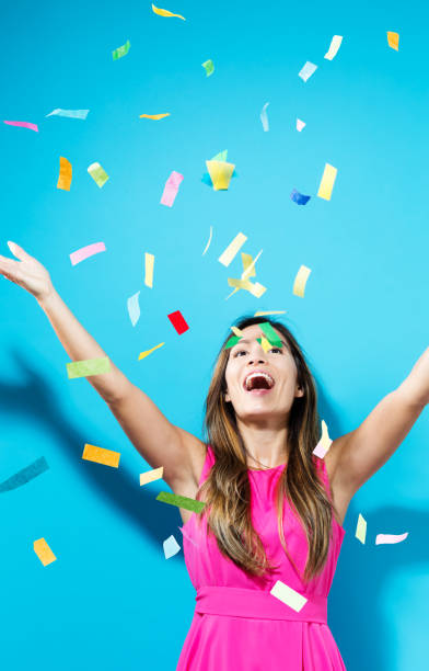 istock Happy woman celebrating with confetti 804178284