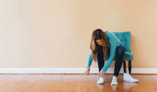 istock Young latina woman tying her shoes 804178292