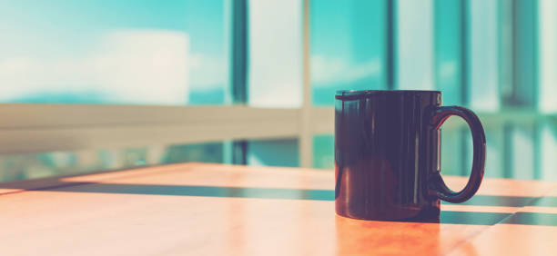 istock Black cup of coffee in brightly lit room 804182630