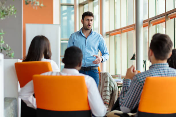 istock business, startup, presentation, strategy and people concept - man making presentation to creative team at office 804190128
