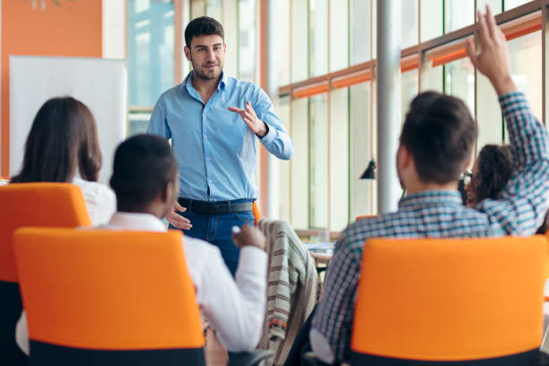 istock business, startup, presentation, strategy and people concept - man making presentation to creative team at office 804191108