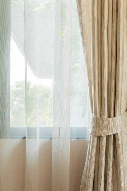 istock Beige curtain by the window 804194190