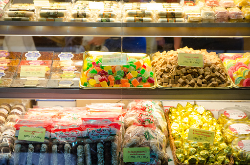 Close up on kiosk of sweet foods like pasties and candies at the Budapest Public Market during day