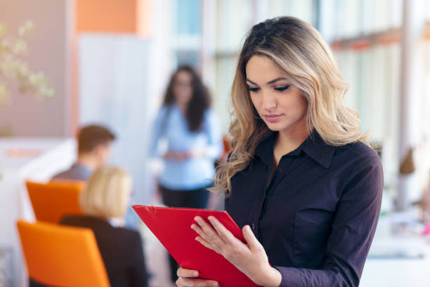 istock Team work discussing. Young woman with paper folder. 804201810
