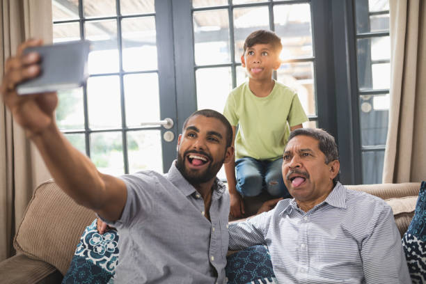 istock Happy multi-generation family making face while taking selfie at home 804208676