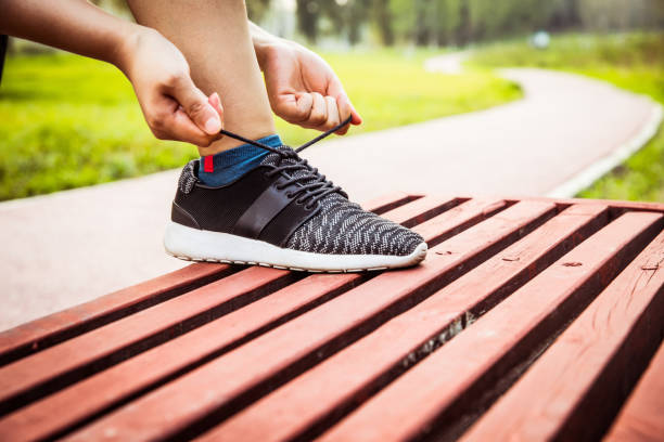 istock Woman hands lacing running shoes 804216170