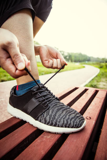 istock Woman hands lacing running shoes 804216188