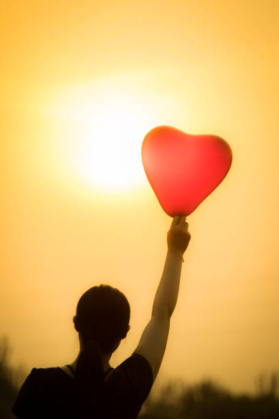 istock young woman hand with balloons 804218578