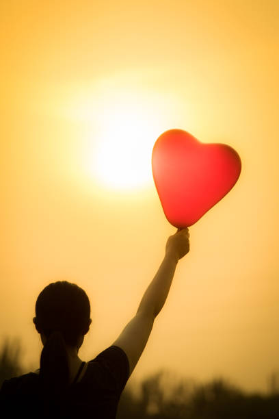 istock young woman hand with balloons 804218600
