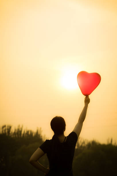 istock young woman hand with balloons 804218606
