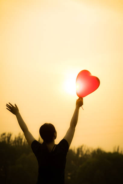 istock young woman hand with balloons 804218608