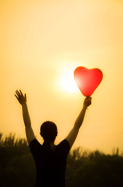 istock young woman hand with balloons 804218612