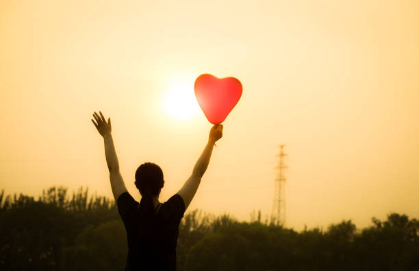 istock young woman hand with balloons 804218622