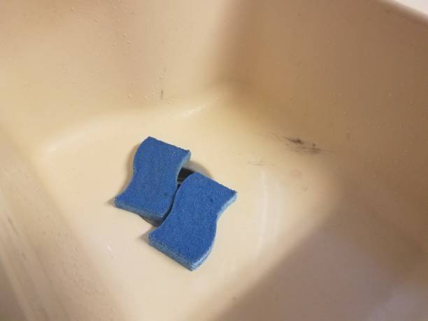istock two blue sponges in a white sink 804226098